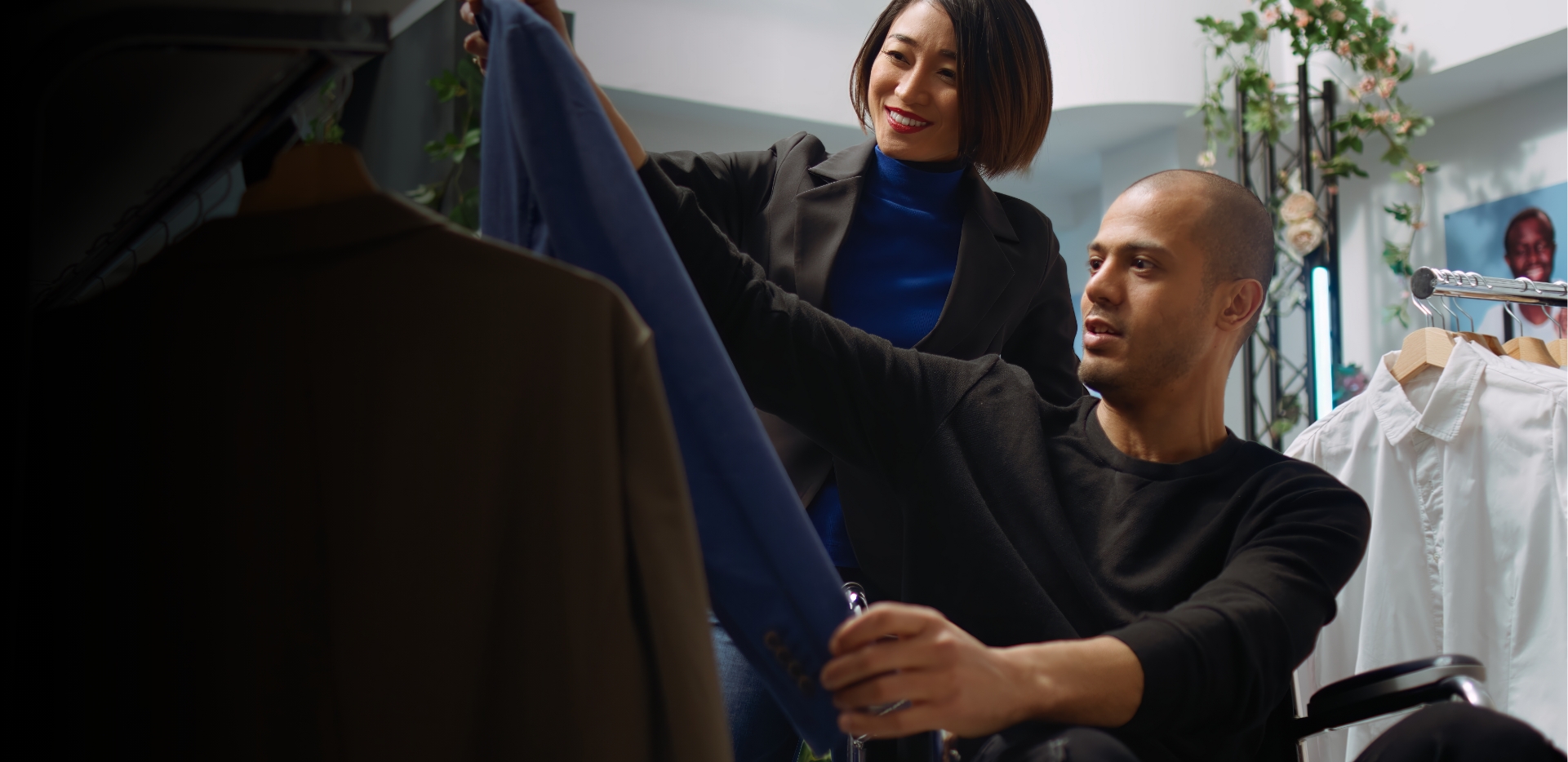 A man and a woman examining clothes in an fashion store